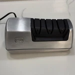 Wolfgang Puck Electric Knife Sharpener BKNS00015 Silver/black 100W W/ Manual. Fixed Price $42.48.