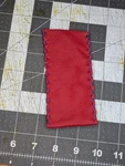Bright Red Leather Knife Slip With Blue X Sticking. Fixed Price $10.00.