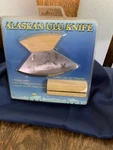 Alaskan Ulu Knife With Wooden Handle Display Base Logos. Fixed Price $15.00.