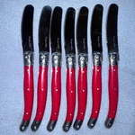 Preowned Cooper & Stainless Red Handled Pate Cheese Spread Knives Set Of 7. Fixed Price $24.00.
