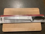 Victorinox Wavy Edge Slicer Knife With Fibrox Handle 12". Fixed Price $55.00.