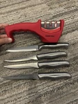 The Sharper Image 4 Knives And Knife Sharpener. Fixed Price $15.00.