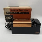 Vintage Oster Deluxe Double Action Electric Knife Scissor Sharpener Box #522. Fixed Price $26.00.