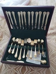 Gold 51-PIECE FLATWAR3 Case, Knife Fork Spoon Serving Set, Glossy Metal. Fixed Price $150.00.
