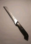 Slitzer Rostfrei 12" Bread Knife Stainless Steel Serrated Blade Black Handle. Fixed Price $12.99.