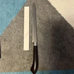 Ginsu Product Vintage Serrated Bread Knife Surgical Stainless Steel Brown Handle. Fixed Price $14.00.